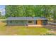 Aerial view of the home showcasing the metal roof, wooden deck, and surrounding yard at 155 Mcallister Rd, Statesville, NC 28625