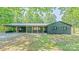 Charming, newly renovated one-story brick home featuring a metal roof and covered carport in a wooded setting at 155 Mcallister Rd, Statesville, NC 28625