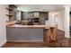 Modern kitchen with gray cabinets, butcher block countertops, and a kitchen island and wood floors at 155 Mcallister Rd, Statesville, NC 28625
