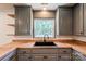 Updated kitchen with gray cabinets, butcher block countertops, and a sleek black sink and faucet at 155 Mcallister Rd, Statesville, NC 28625