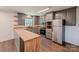 Updated kitchen features stainless steel appliances, gray cabinets, and butcher block countertops at 155 Mcallister Rd, Statesville, NC 28625