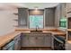 Updated kitchen featuring gray cabinets, butcher block countertops, and modern appliances at 155 Mcallister Rd, Statesville, NC 28625