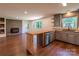 Open concept living area featuring a brick fireplace, wood floors and views to the backyard at 155 Mcallister Rd, Statesville, NC 28625