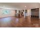 Open living room features a kitchen area, built-in storage, and stylish gray cabinets and wood floors at 155 Mcallister Rd, Statesville, NC 28625