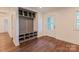 Mudroom with built-in storage bench and cubbies, adjacent to an exterior door and wood floors at 155 Mcallister Rd, Statesville, NC 28625