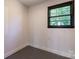 Small empty room with a single window, utility access, and gray flooring at 155 Mcallister Rd, Statesville, NC 28625