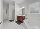 Bathroom featuring a soaking tub, single vanity, tiled floors and walk-in shower at 163 Shoreline Pkwy, Tega Cay, SC 29708