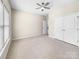 Neutral bedroom featuring carpet, and a ceiling fan and multiple closets for storage at 163 Shoreline Pkwy, Tega Cay, SC 29708