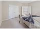 Bedroom featuring a bed, closet, and an open doorway to another room at 163 Shoreline Pkwy, Tega Cay, SC 29708