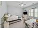 Cozy bedroom with a ceiling fan, bed, dresser, and ample natural light at 163 Shoreline Pkwy, Tega Cay, SC 29708