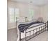 Bright bedroom with a queen bed, two windows, and neutral color palette at 163 Shoreline Pkwy, Tega Cay, SC 29708