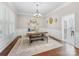Elegant dining room with stylish chandelier, wainscoting, and view of the kitchen at 163 Shoreline Pkwy, Tega Cay, SC 29708