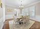 Inviting dining room featuring wainscoting, a modern chandelier, and seating for six at 163 Shoreline Pkwy, Tega Cay, SC 29708
