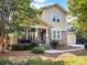 Charming two-story home with stone accents, inviting front porch, and well-maintained landscaping at 163 Shoreline Pkwy, Tega Cay, SC 29708