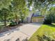 Charming two-story home with two-car garage, driveway, and mature shade trees in front yard at 163 Shoreline Pkwy, Tega Cay, SC 29708