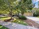 Charming home featuring a two car garage, stone accents, and a well-manicured lawn with mature trees at 163 Shoreline Pkwy, Tega Cay, SC 29708