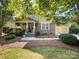 Inviting home with stone and siding, a cozy front porch, and lush landscaping creating curb appeal at 163 Shoreline Pkwy, Tega Cay, SC 29708