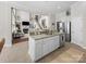 Open floor plan kitchen with stainless steel appliances and granite counters flows into the living room at 163 Shoreline Pkwy, Tega Cay, SC 29708