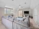 Large living room with comfortable seating, window shutters, ceiling fan, and TV at 163 Shoreline Pkwy, Tega Cay, SC 29708