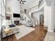 Bright living room with hardwood floors, fireplace, and a staircase leading to the upper level at 163 Shoreline Pkwy, Tega Cay, SC 29708
