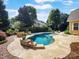 Resort-style pool and patio with lush landscaping and ample seating at 163 Shoreline Pkwy, Tega Cay, SC 29708