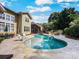 Backyard oasis featuring a kidney-shaped pool, patio furniture and verdant landscaping at 163 Shoreline Pkwy, Tega Cay, SC 29708