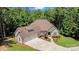 An elevated view of a well-manicured home with a three-car garage, lush landscaping, and a spacious driveway at 1687 Sierra Rd, York, SC 29745
