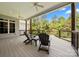 Covered back porch with ceiling fans and outdoor seating, overlooking the backyard and mature trees at 1687 Sierra Rd, York, SC 29745