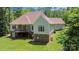 Backyard view of the deck and patio in a large yard, framed by mature trees for privacy at 1687 Sierra Rd, York, SC 29745