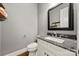 Elegant half bathroom features a granite countertop and decorative mirror at 1687 Sierra Rd, York, SC 29745
