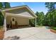 Carport with an attached garage, providing ample parking and storage space with mature trees at 1687 Sierra Rd, York, SC 29745