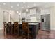 Gourmet kitchen island features barstool seating, pendant lighting, stainless steel appliances, and white cabinets at 1687 Sierra Rd, York, SC 29745