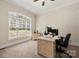 Well-lit office featuring a ceiling fan, window with natural light, neutral carpet, and a workstation at 1687 Sierra Rd, York, SC 29745