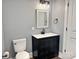 Bathroom featuring modern vanity with black fixtures, toilet, neutral paint, and wood-look floors at 201 Barnes Ln, Stony Point, NC 28678