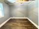 Empty bedroom featuring wood-look floors, gray walls, white ceiling, and a window for natural light at 201 Barnes Ln, Stony Point, NC 28678