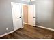 Neutral bedroom featuring wood-look floors, light gray walls, and white trim at 201 Barnes Ln, Stony Point, NC 28678