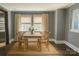 Dining room bathed in natural light features a simple table setting and neutral decor at 201 Barnes Ln, Stony Point, NC 28678