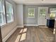 Empty room features beautiful hardwood flooring and natural light from the windows, inviting design possibilities at 201 Barnes Ln, Stony Point, NC 28678