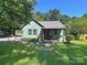 Charming home with a metal roof, quaint front porch, and lush yard, offering a welcoming curb appeal at 201 Barnes Ln, Stony Point, NC 28678