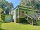 The home's back exterior features a covered porch with wood railing and green siding at 201 Barnes Ln, Stony Point, NC 28678