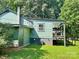 The home's back exterior features a deck with wood railing and green siding at 201 Barnes Ln, Stony Point, NC 28678