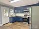 Contemporary kitchen featuring stainless steel appliances, dark blue cabinets, and stylish backsplash at 201 Barnes Ln, Stony Point, NC 28678