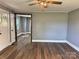 Bright living room with hardwood floors, neutral paint, and natural light from window and doorway at 201 Barnes Ln, Stony Point, NC 28678