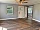 Bright living room featuring hardwood floors, neutral paint, and natural light from window and doorway at 201 Barnes Ln, Stony Point, NC 28678