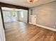 Bright living room featuring hardwood floors, neutral paint, and natural light from window and doorway at 201 Barnes Ln, Stony Point, NC 28678