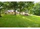 Spacious backyard featuring lush greenery, a detached garage, and a charming gazebo at 2028 Old Latter Rd, Newton, NC 28658