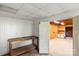 An unfinished basement area with wooden workbench and paneled walls adjacent to a lit workroom at 2028 Old Latter Rd, Newton, NC 28658