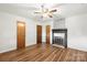 Spacious bedroom with wood-look flooring, ceiling fan, and decorative fireplace at 2028 Old Latter Rd, Newton, NC 28658