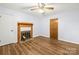 Inviting bedroom featuring wood-look flooring, ceiling fan, and a cozy fireplace at 2028 Old Latter Rd, Newton, NC 28658