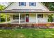 Inviting front porch with brick base, white columns, and a red front door at 2028 Old Latter Rd, Newton, NC 28658
